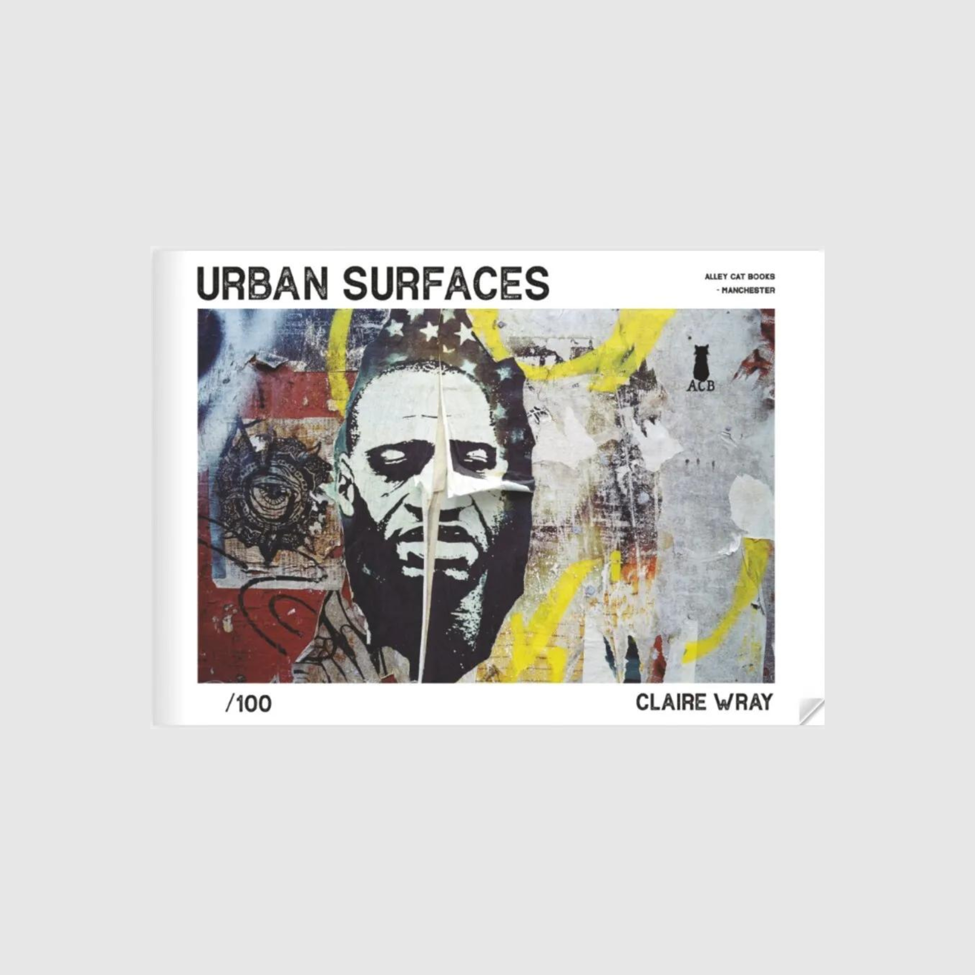 Cover of the zine "Urban Surfaces" by Claire Wray. The cover features a textured wall with a street art image of a man's face, partially peeled. The zine title "Urban Surfaces" is prominently displayed at the top, with "Claire Wray" and "Alley Cat Books, Manchester" printed on the bottom right. The edition is noted as "/100"