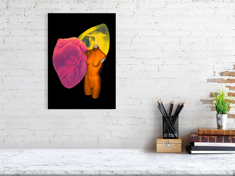 A surreal artwork titled 'Over My Dead Body!' by Elizabeth Corrall. It features a headless orange mannequin torso, a vibrant red anatomical heart, and a yellow eye against a black background. This A3-sized giclée print is part of a limited edition series of 50, printed on Ilford cotton textured paper.