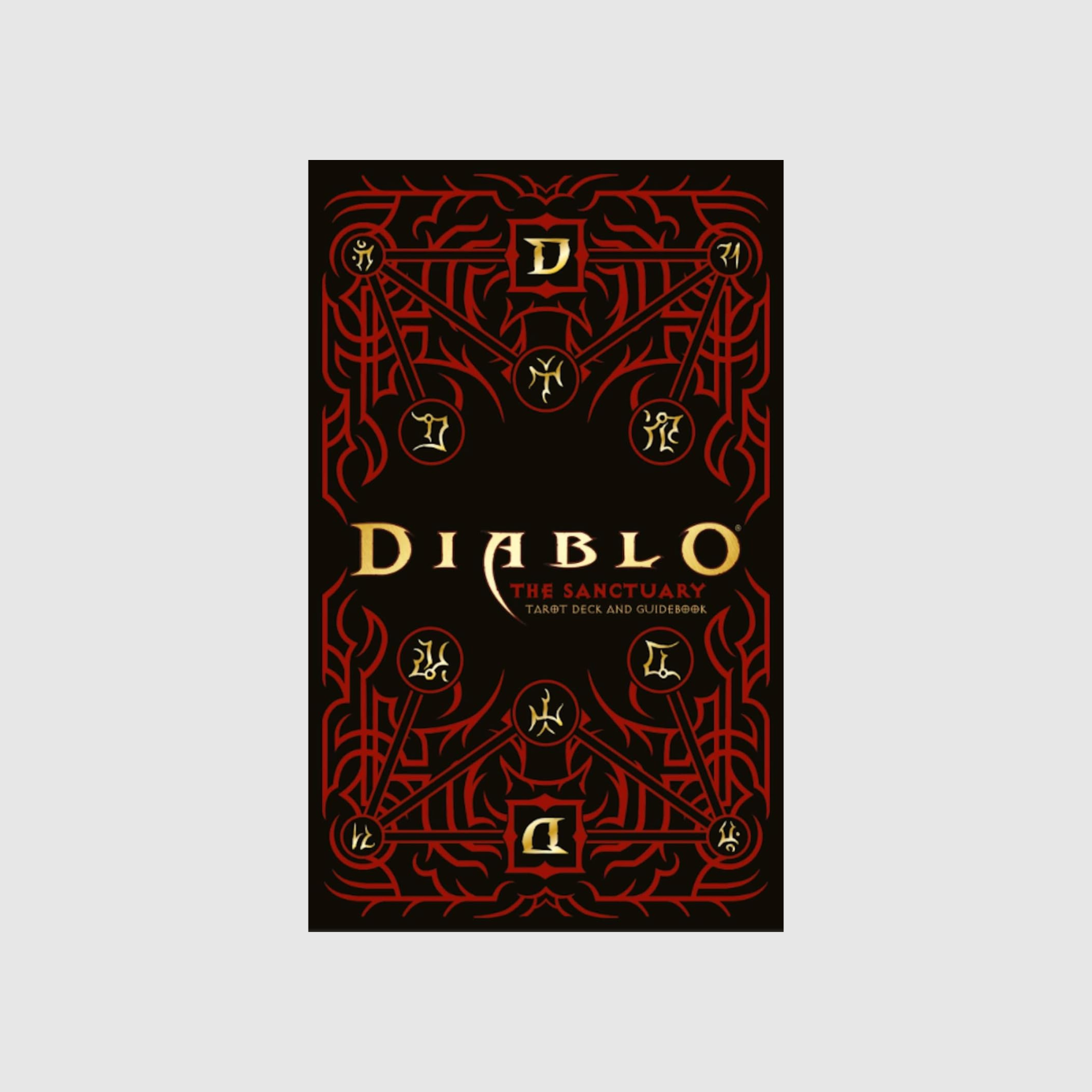 This image showcases the box design for The Sanctuary Tarot Deck and Guidebook, inspired by Blizzard Entertainment’s Diablo series. The cover features intricate red and gold artwork reflecting the dark, magical world of Sanctuary. Central to the design is the Diablo logo, with mystical symbols and patterns that evoke the essence of the game's mythos. This visually striking box art emphasizes the blend of horror and beauty that defines the Sanctuary tarot set.