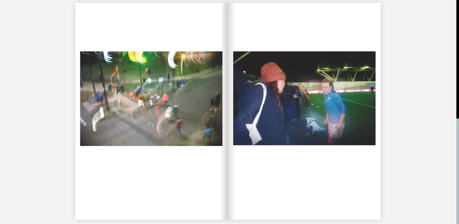 Two-page spread from the zine "The Women's Game" by Claire Wray. The left page shows a blurred, night-time street scene with people walking and colorful lights streaking through the image, creating a sense of motion. The right page features a football player in a blue jersey and white shorts, interacting with a fan wearing a red beanie hat. They are at the edge of a football field, with the stadium lights illuminating the scene in the background.